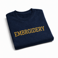 Folded navy blue sweatshirt with 'EMBROIDERY' in yellow text on a white background