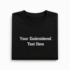 Black folded t-shirt with customizable text on a white background